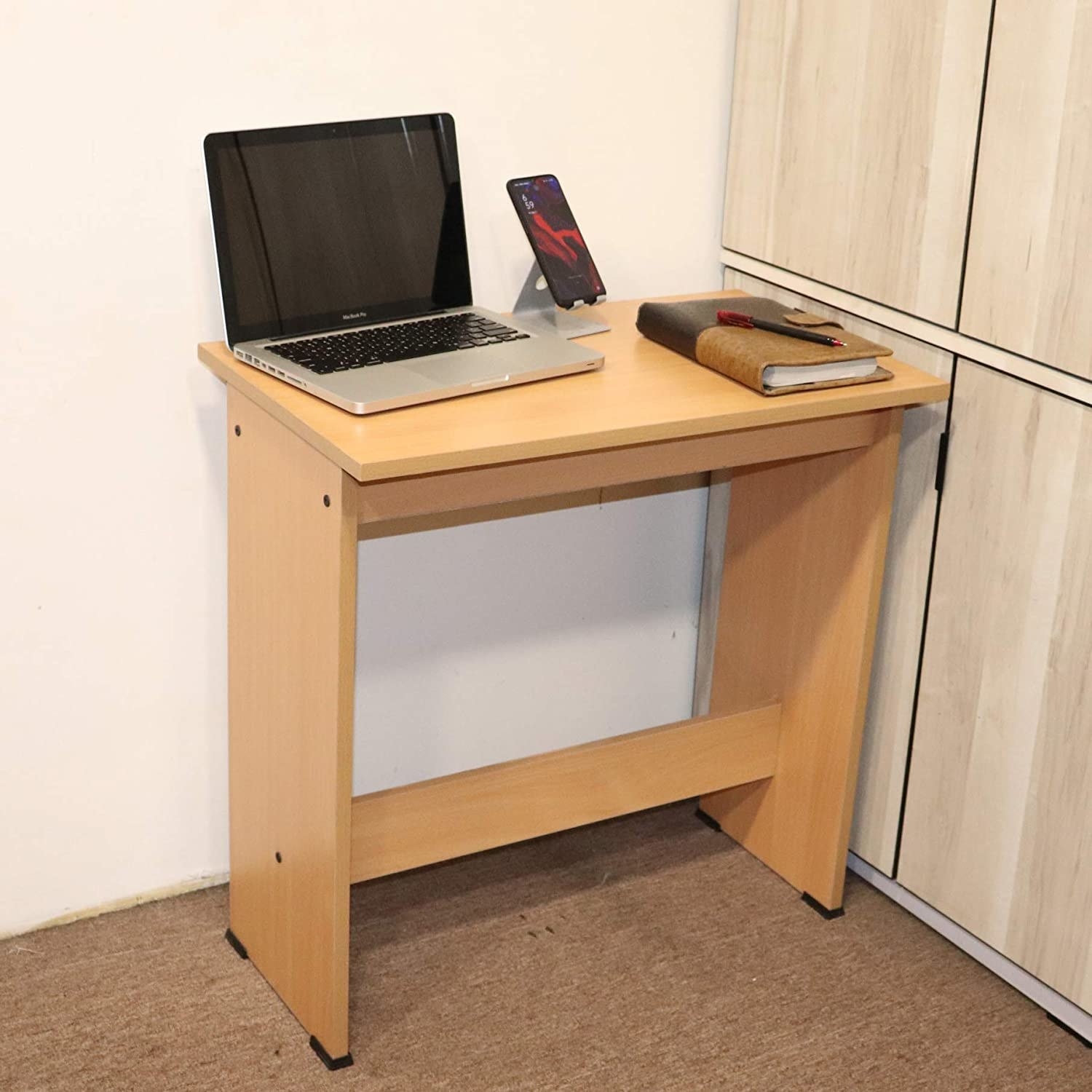A brown table with a laptop on it 