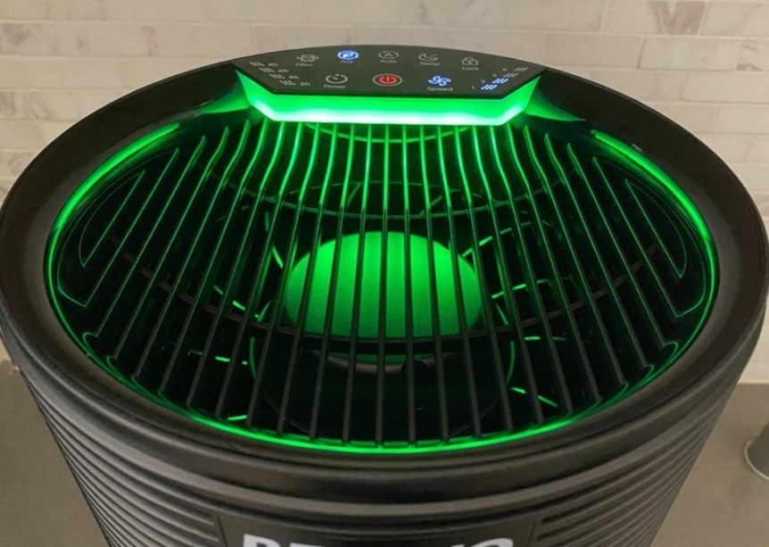 A close up of the green top of an air purifier