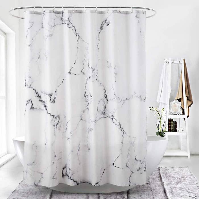 the shower curtain around a tub