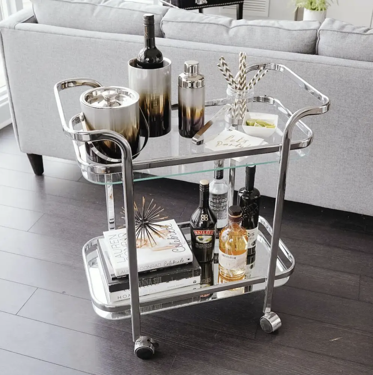 the bar cart filled with bottles of alcohol and books