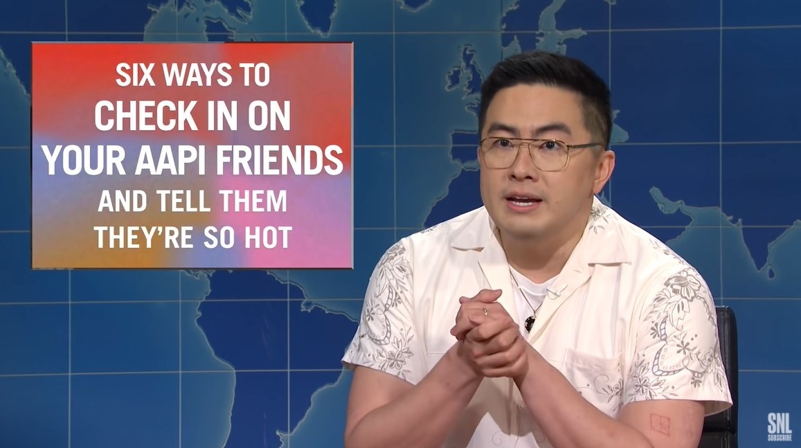 Bowen Yang on Weekend Update next to &quot;Six Ways to Check in on Your AAPI Friends and Tell Them They&#x27;re So Hot&quot; infographic