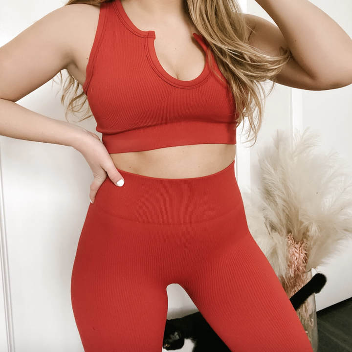 reviewer wearing the red activewear set