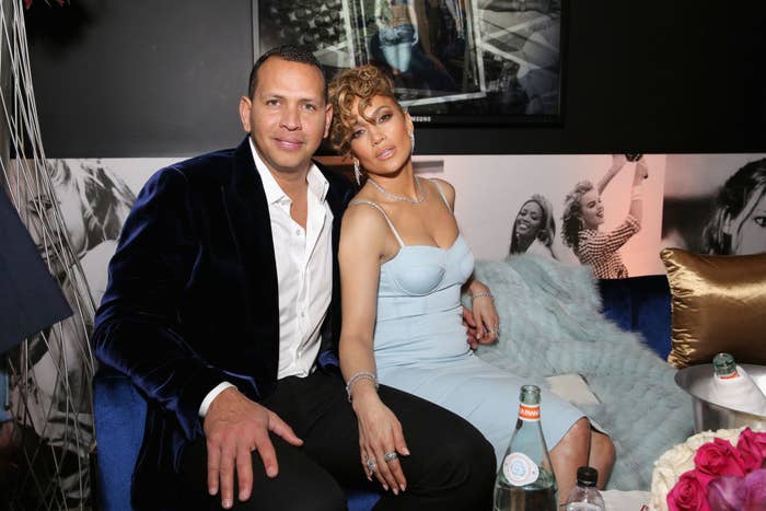 Alex and Jennifer posing for a photo on a couch at an event