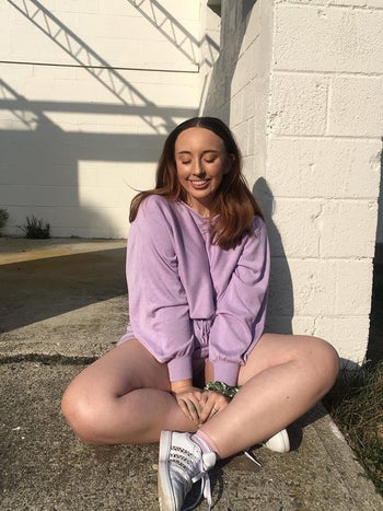 Reviewer wearing the shorts and long-sleeved sweatsuit set in purple