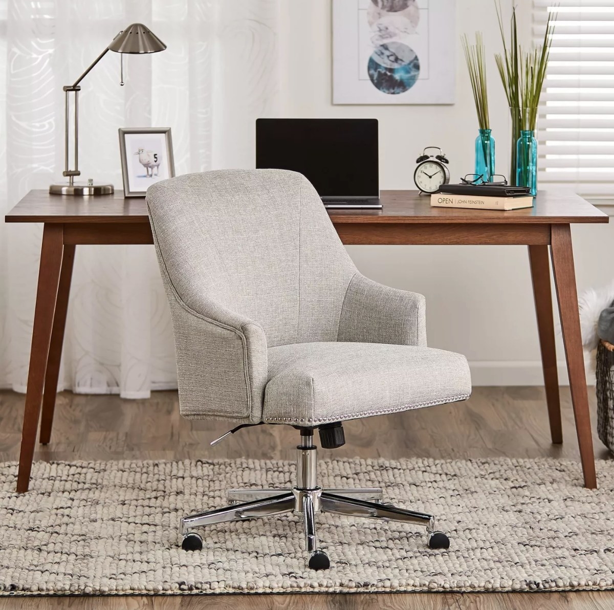 The home office chair in gray with metal legs and rolling wheels