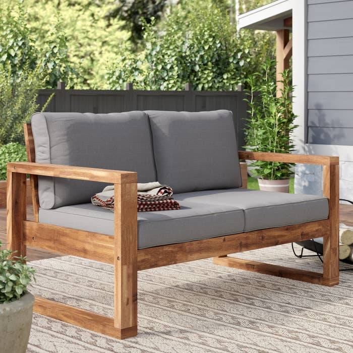 wooden couch with gray cushions