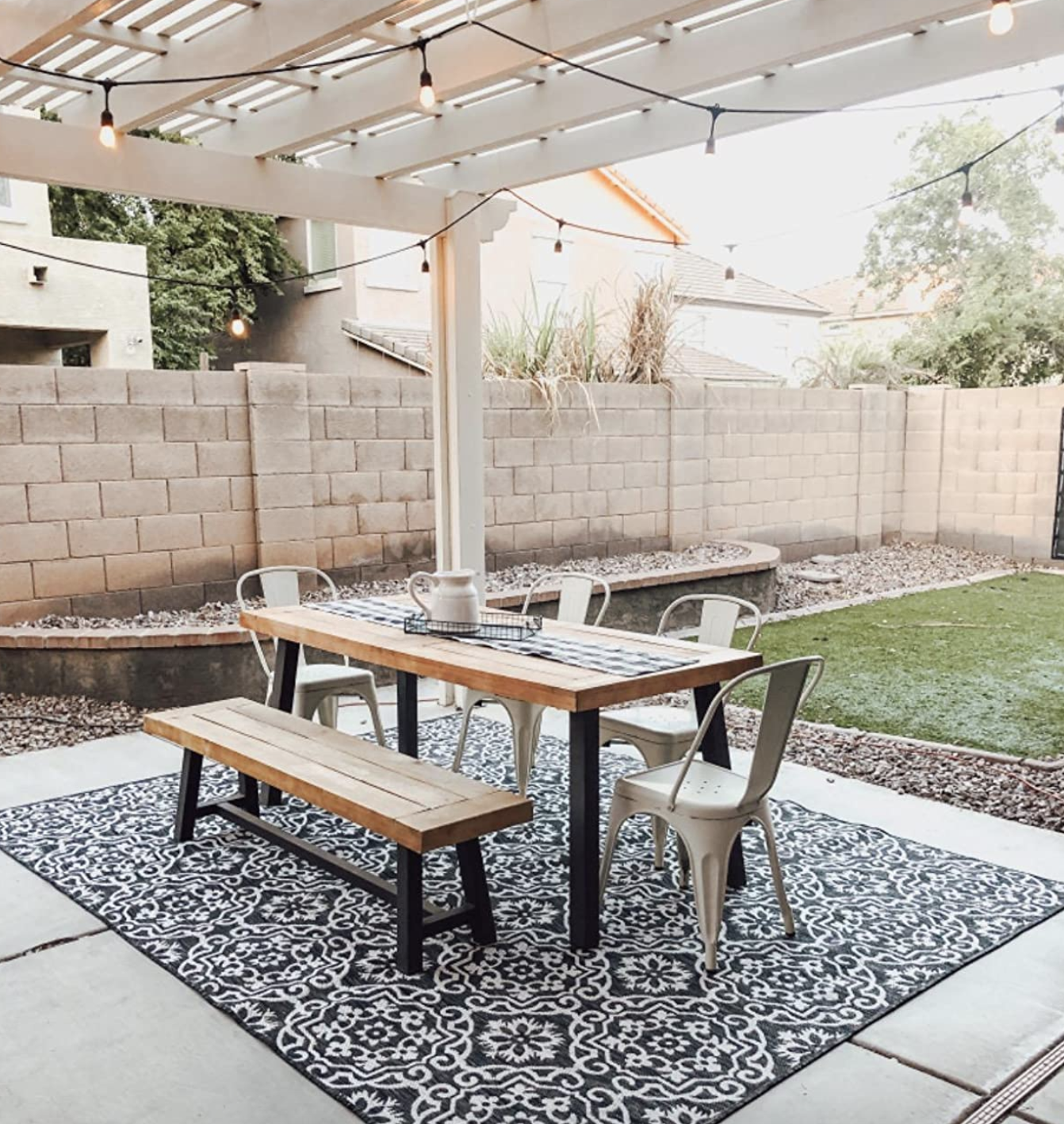 reviewer image of patio rug styled under/outside dining table