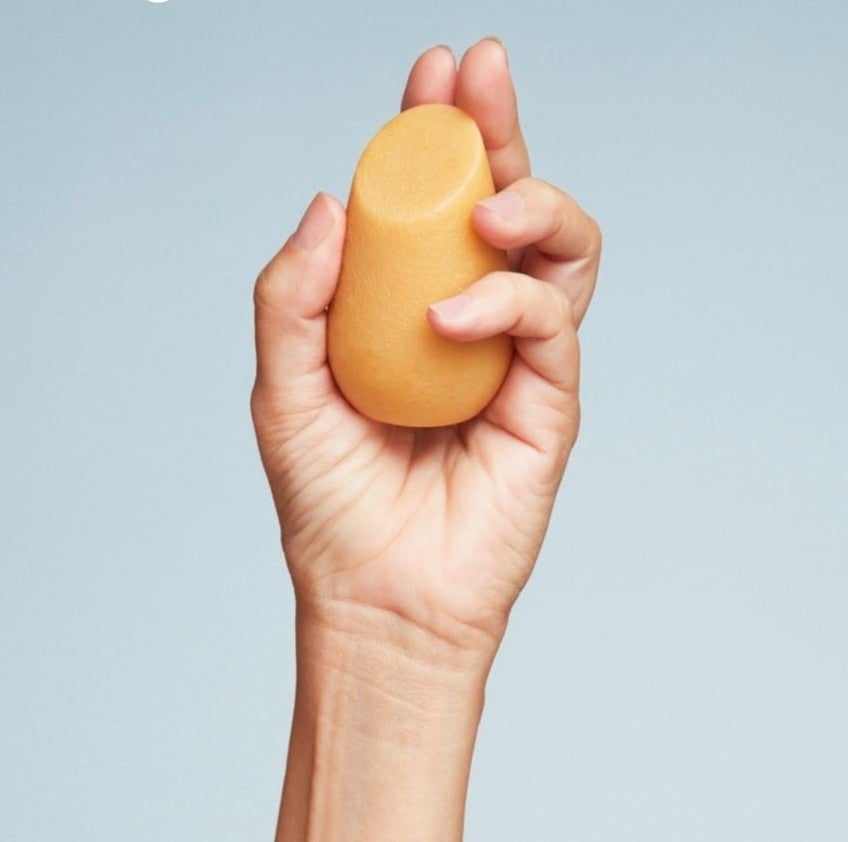 A person holding up one of the shampoo bars