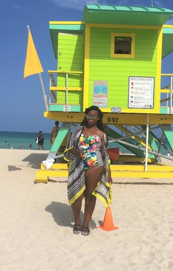 a different reviewer wearing the coverup in black and white pattern with yellow hem over a swimsuit