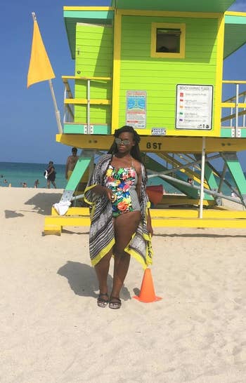 a different reviewer wearing the coverup in black and white pattern with yellow hem over a swimsuit