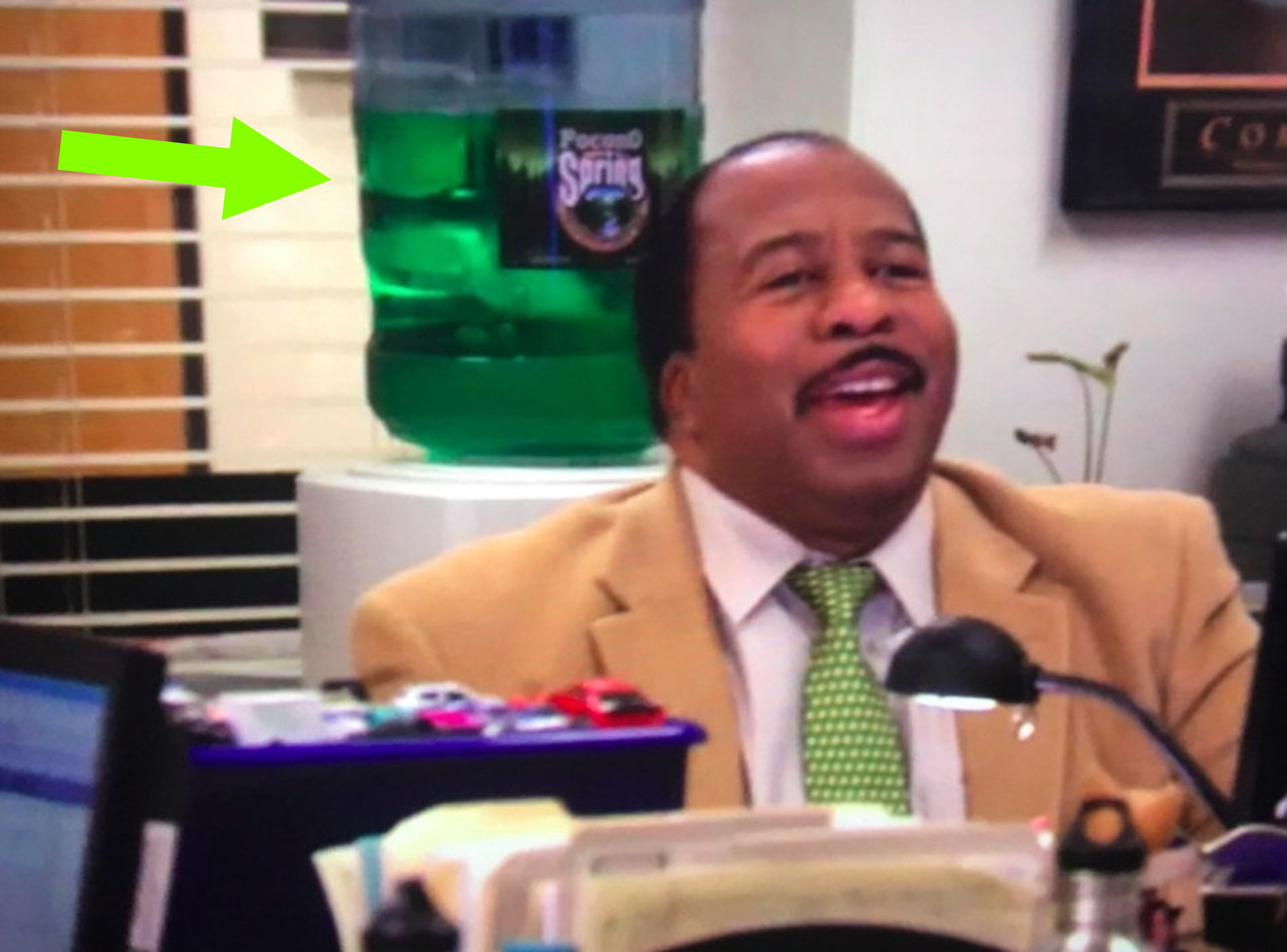 Stanley sitting at his desk and, in a rare occurrence, smiling