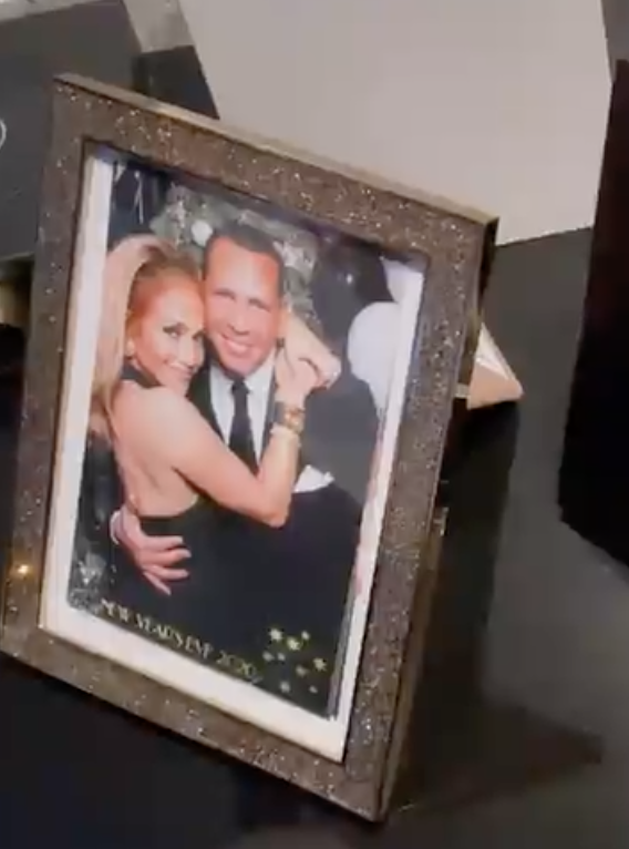 Framed photo of Arod and J.Lo with her arms around him as they smile