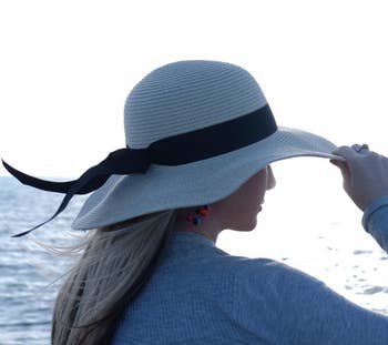 A reviewer's hat from the back, with the ribbon waving in the wind