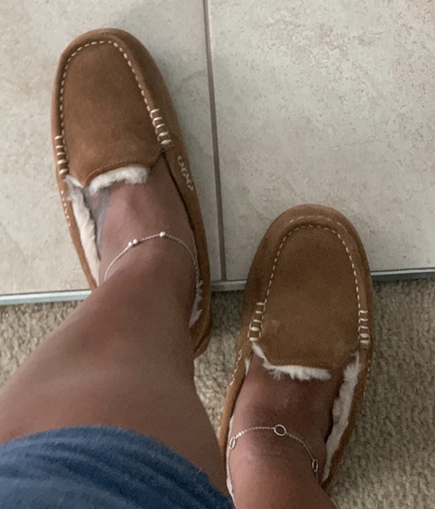 A reviewer wearing moccasin slippers