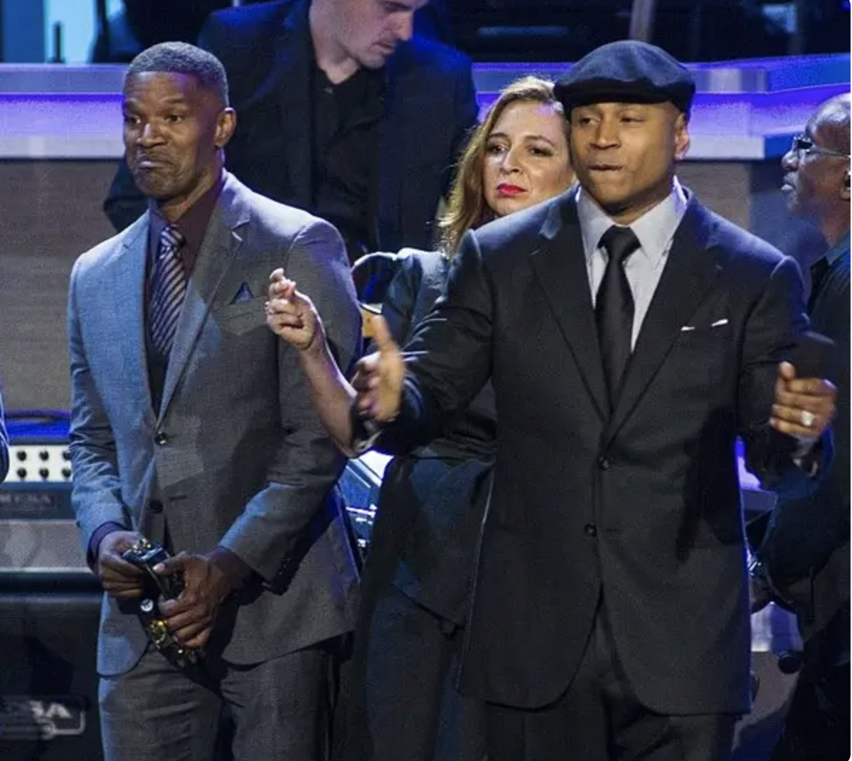 Jamie Foxx and LL Cool J dance onstage wearing suits