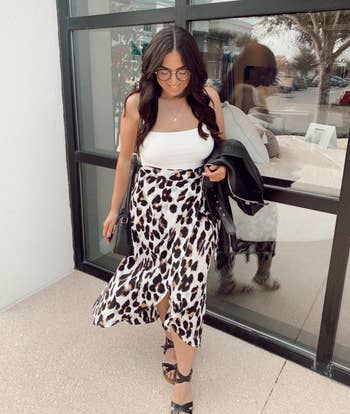 Reviewer wearing white leopard print wrap skirt