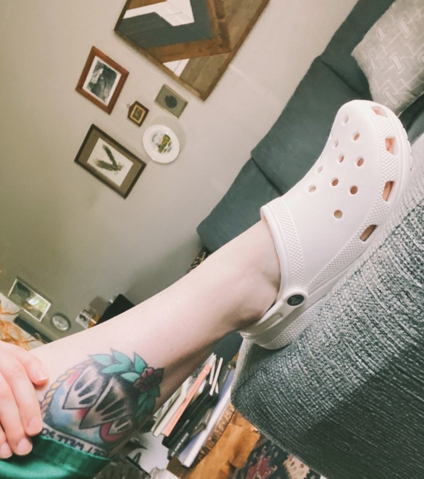 A person wearing white Crocs