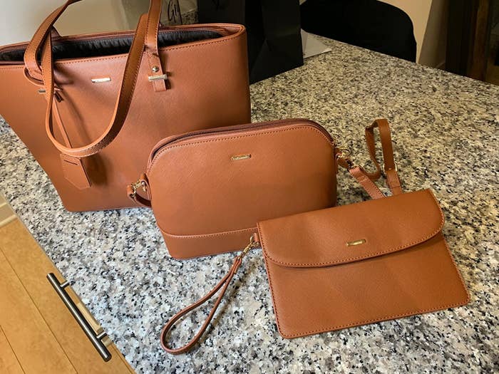 Three piece purse set on table