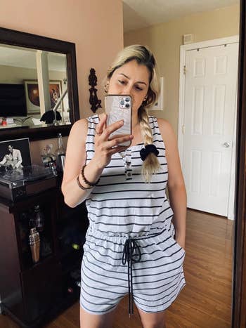 reviewer wearing white striped romper