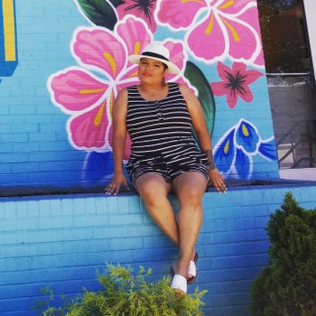 reviewer wearing the black striped romper