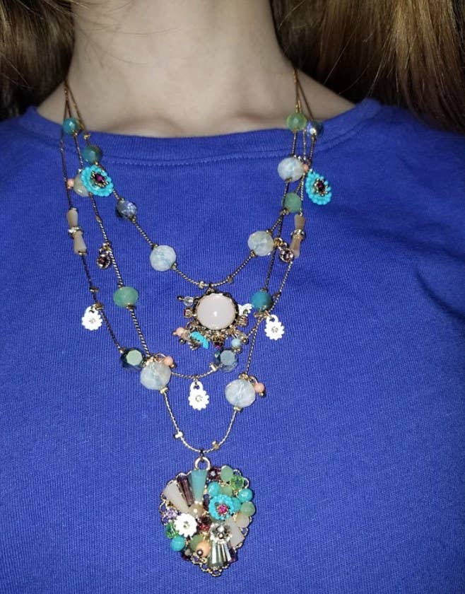 A reviewer wearing the layered necklace 