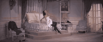 Cyd Charisse twirling around a bedroom