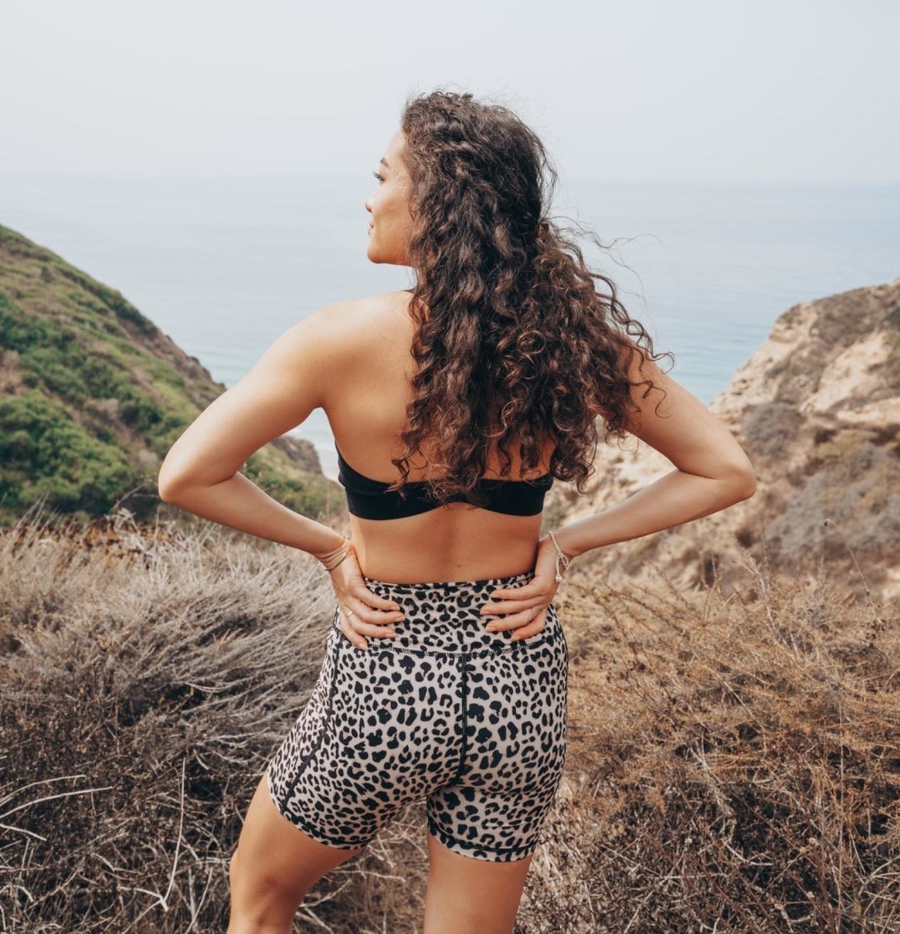 Reviewer showing the back of her leopard print shorts