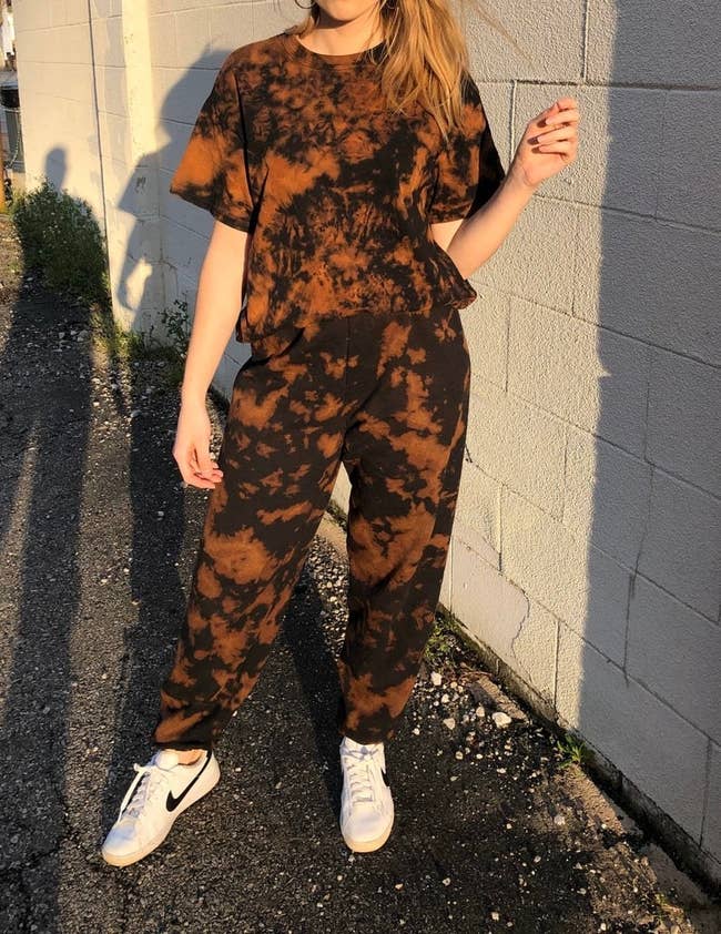 model wears matching brown and black tie-dye T-shirt and sweatpants