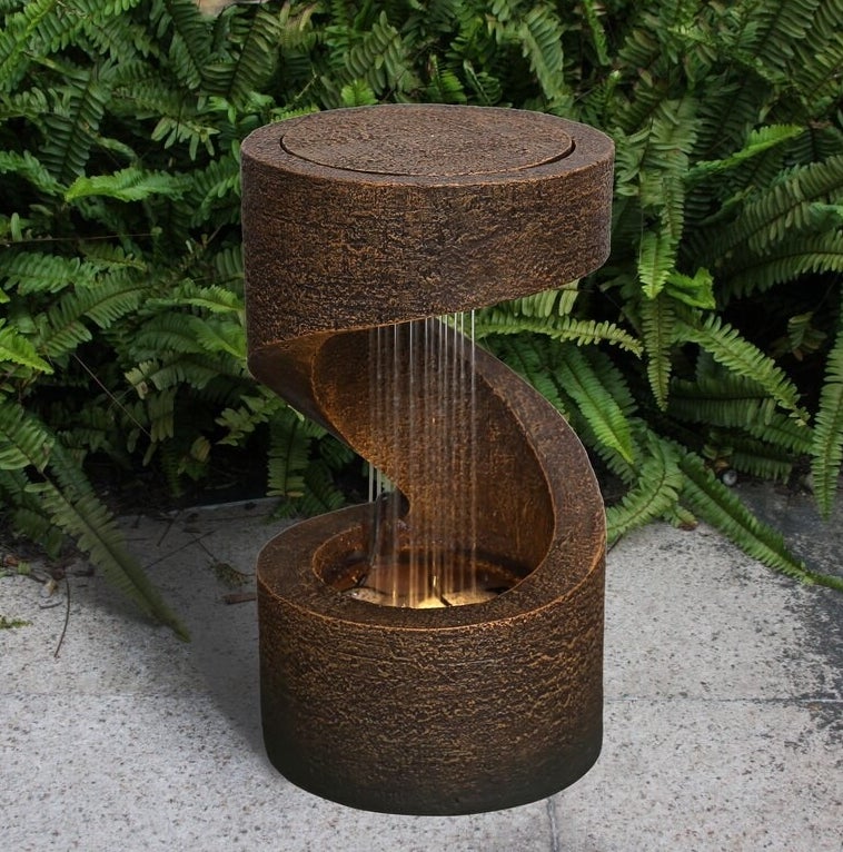 small spiral style water fountain with a light at the bottom to light up the water