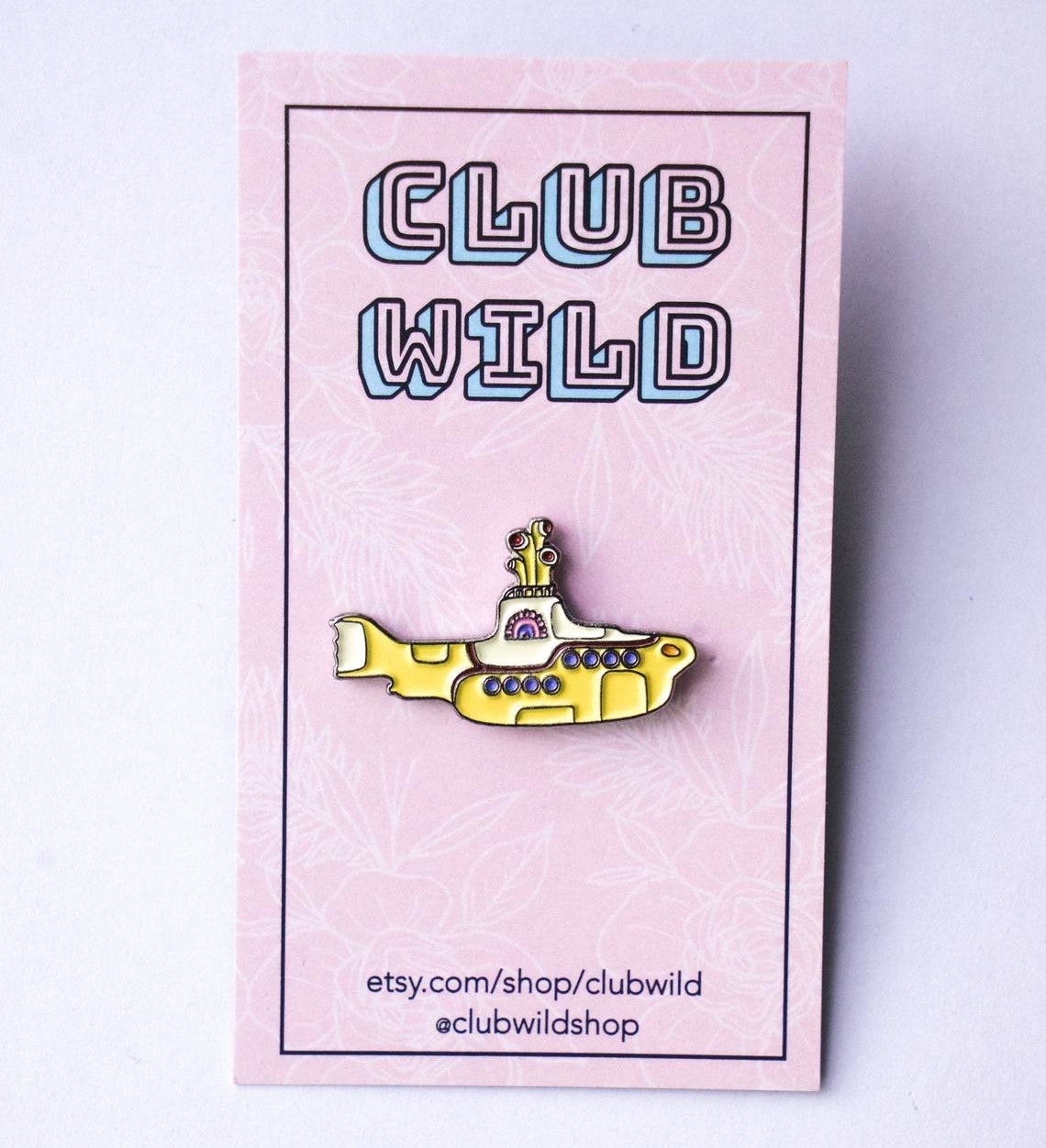 A ceramic yellow submarine pin  on a card 