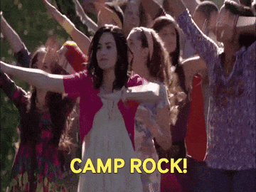 Mitchie and the other Camp Rockers doing weird dance movements as they march and shout Camp Rock