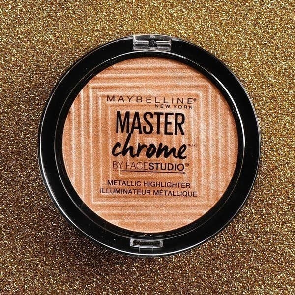 master chrome highlighter against gold glitter background
