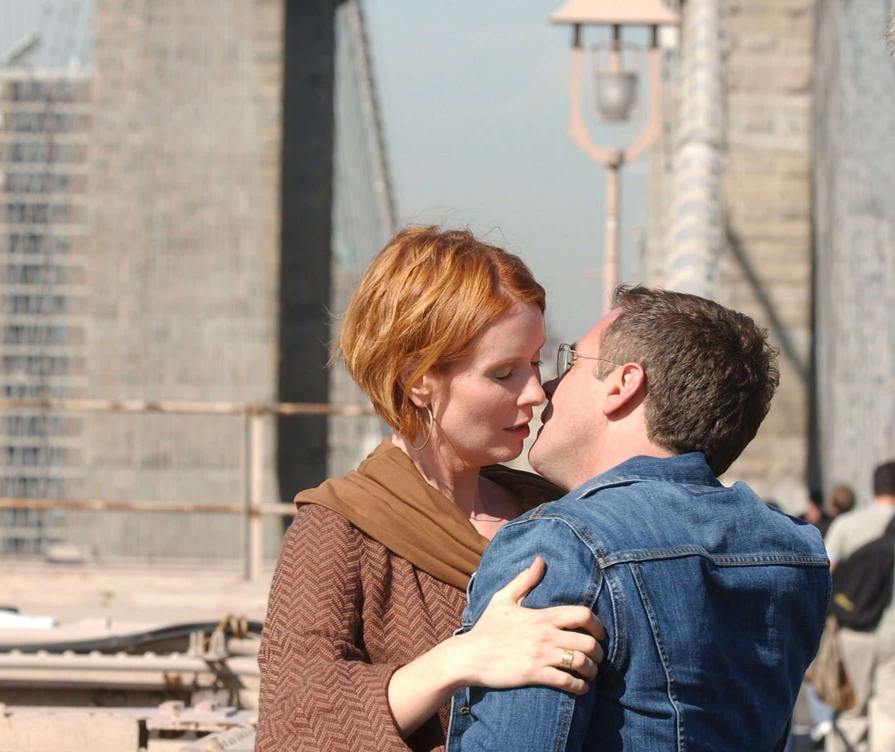 Miranda and Steve embrace on a bridge