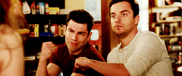 Two guys bumping fists in New Girl