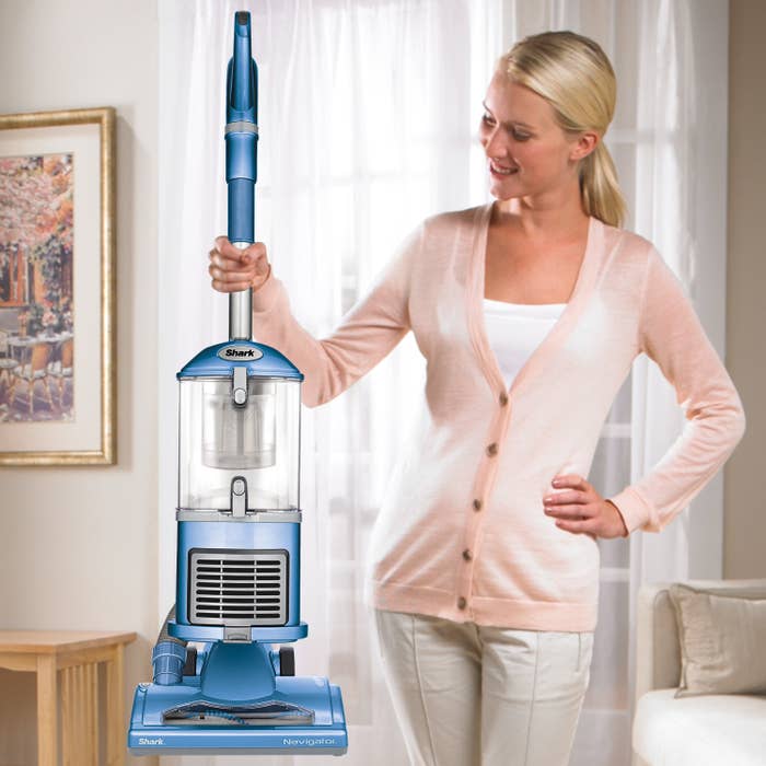 model holding upright vacuum with clear dirt bin cannister