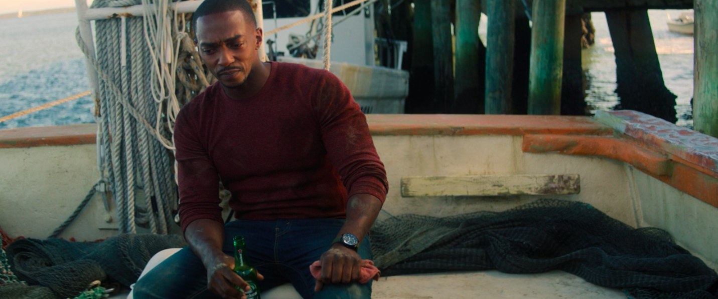 Anthony Mackie holding a Heineken on the boat