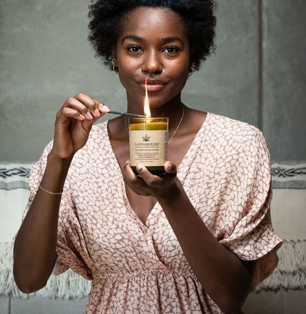 A person lighting the candle