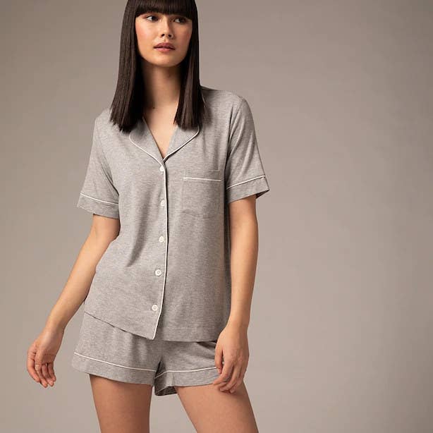 A person wearing a pyjamas shirt and matching shorts