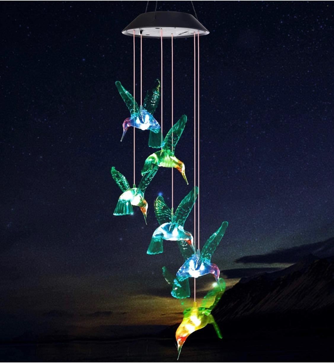 The hummingbird wind chimes against a dark night sky