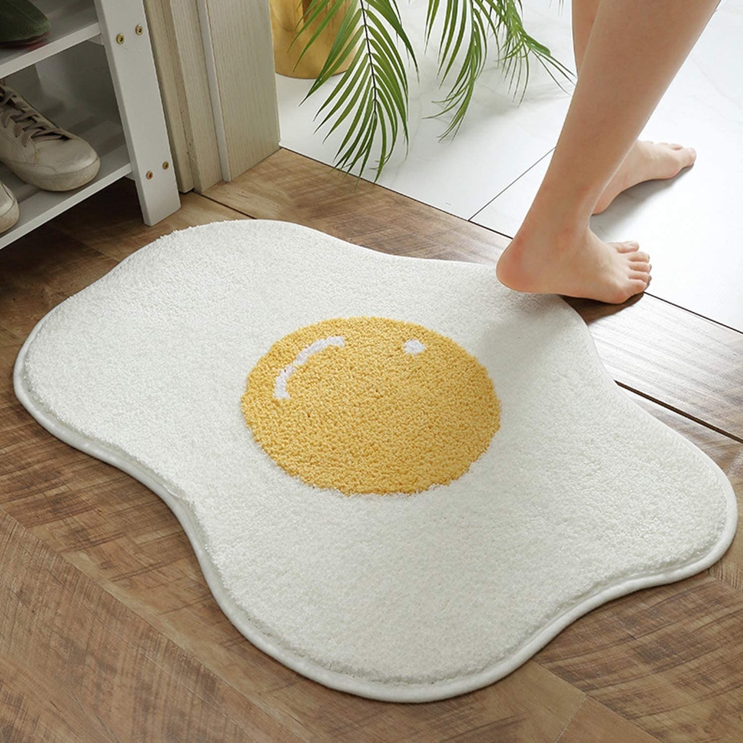 the white and yellow egg-shaped mat