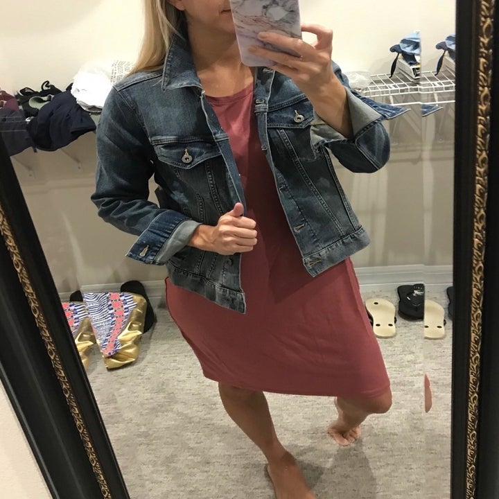 reviewer wearing the jacket in medium wash denim 