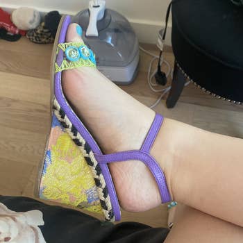 My foot in the lavender wedge with floral brocade on the heel and contrasting braided rope trim