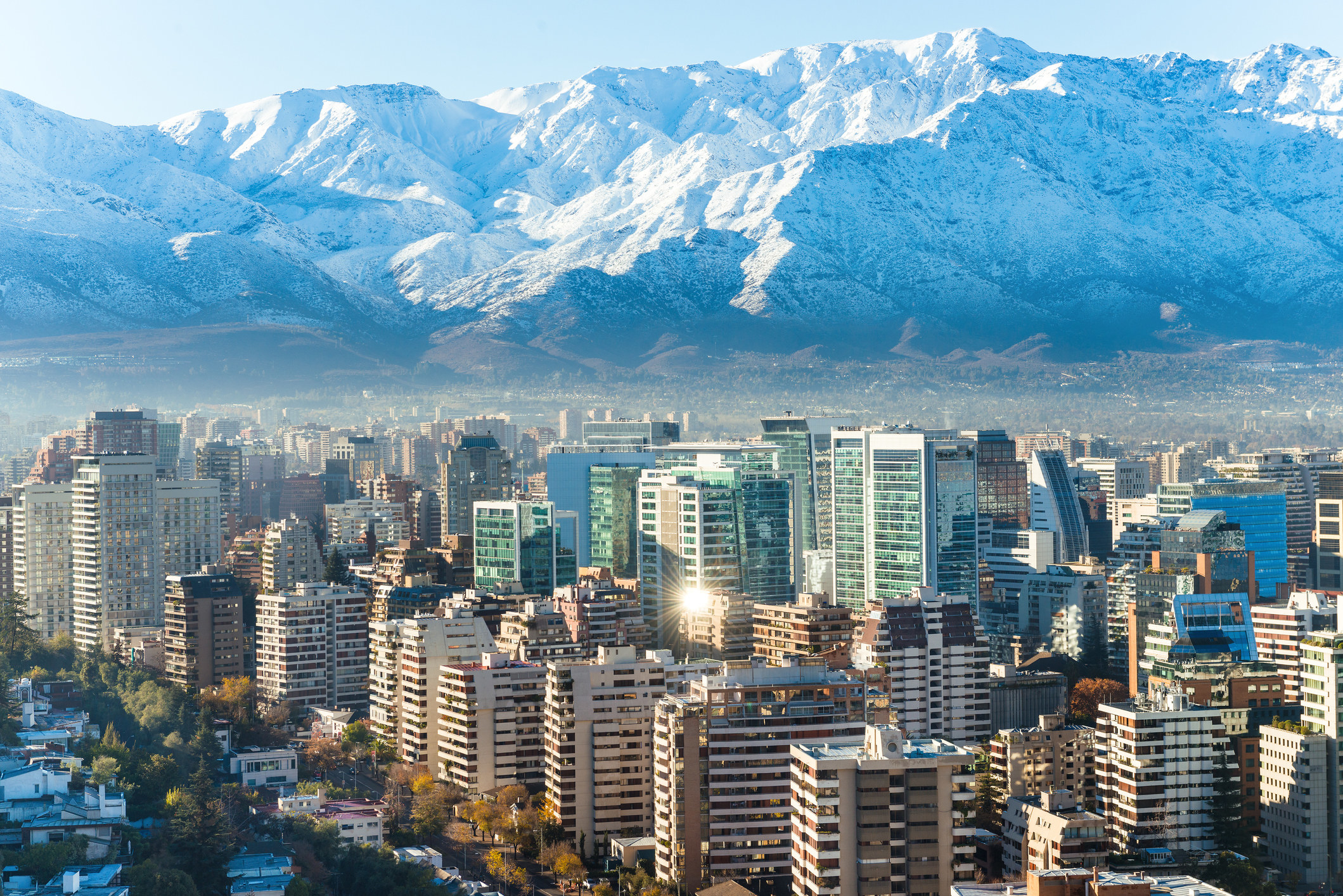 The city of Santiago nestled at the base of the mountains