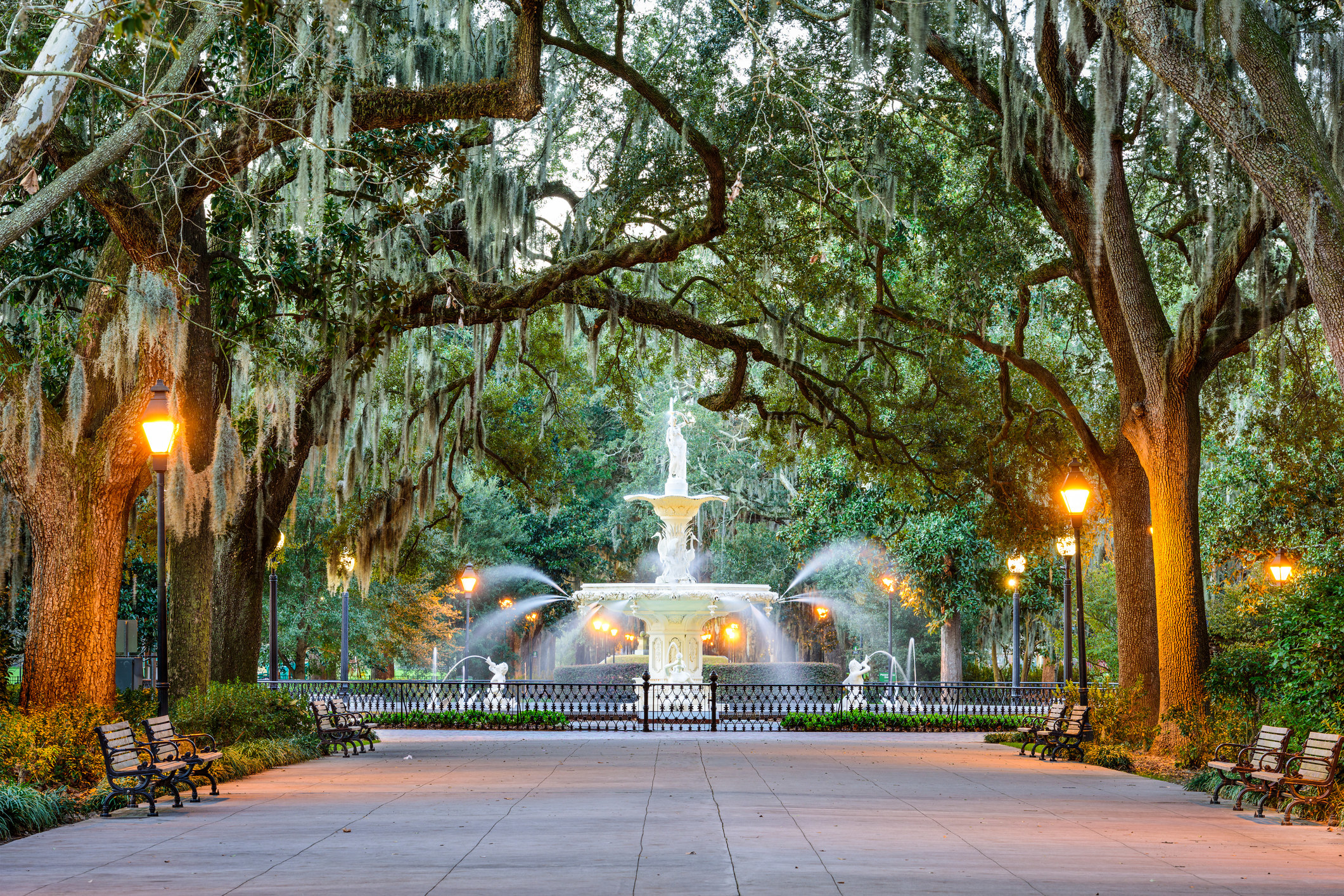 Fountain in a park in Savannah surrounded by trees covered in hanging moss