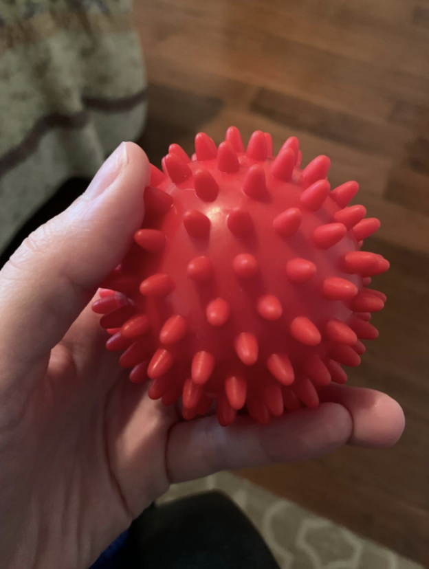 hand holding a spiky massage ball