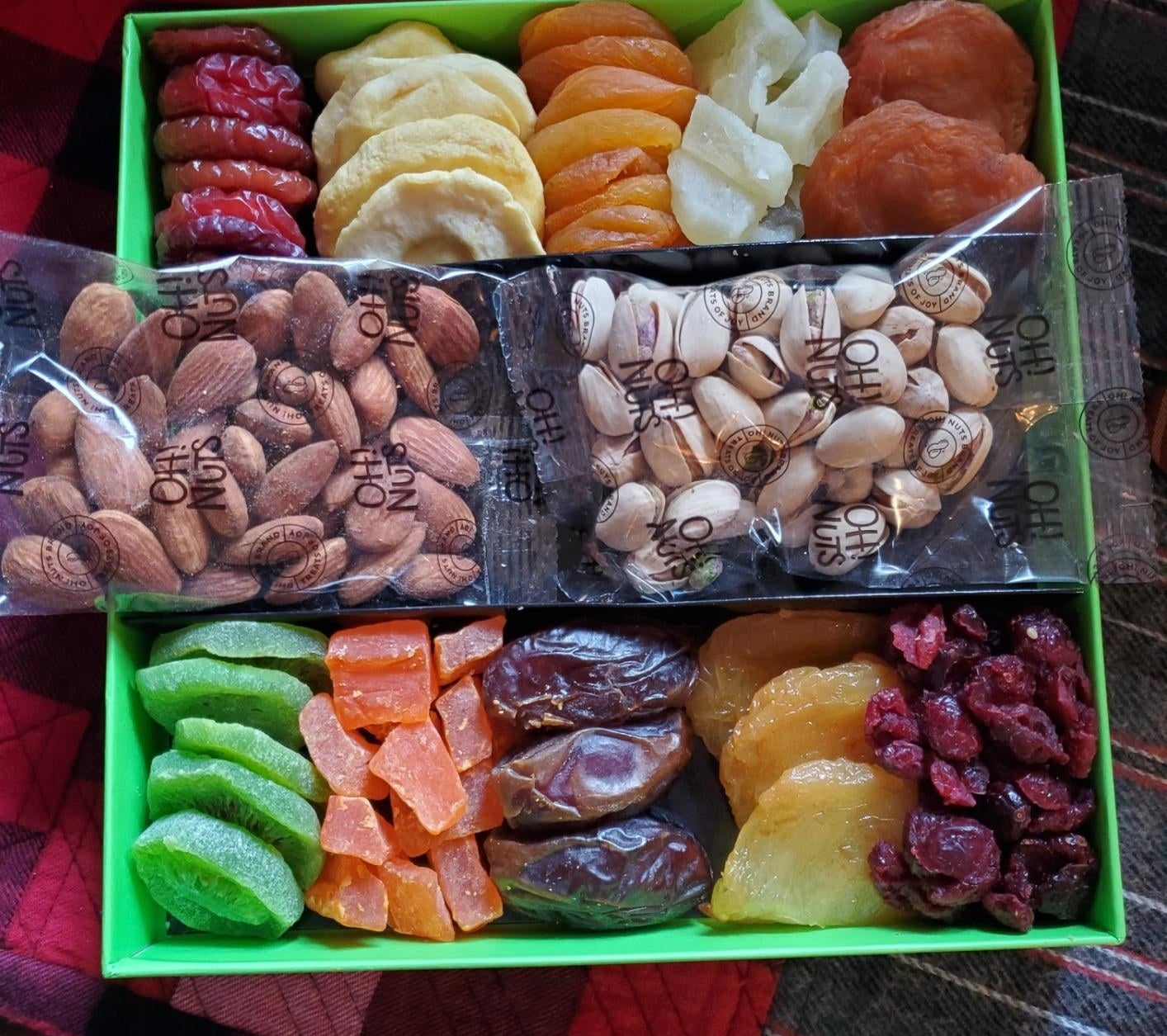 a reviewer photo of the gift box filled with dried, candied fruits and nuts 
