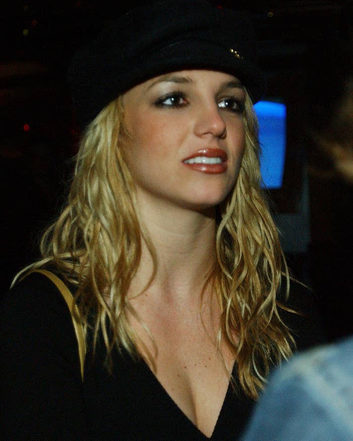 A serious-looking Britney wearing a black hat and black outfit