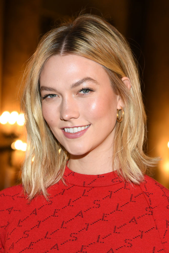 Karlie smiling and wearing a red top