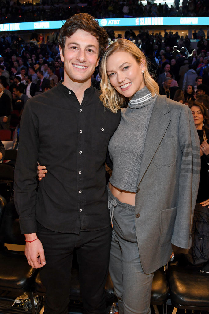 Josh and Karlie standing together with Karlie&#x27;s arm around his waist