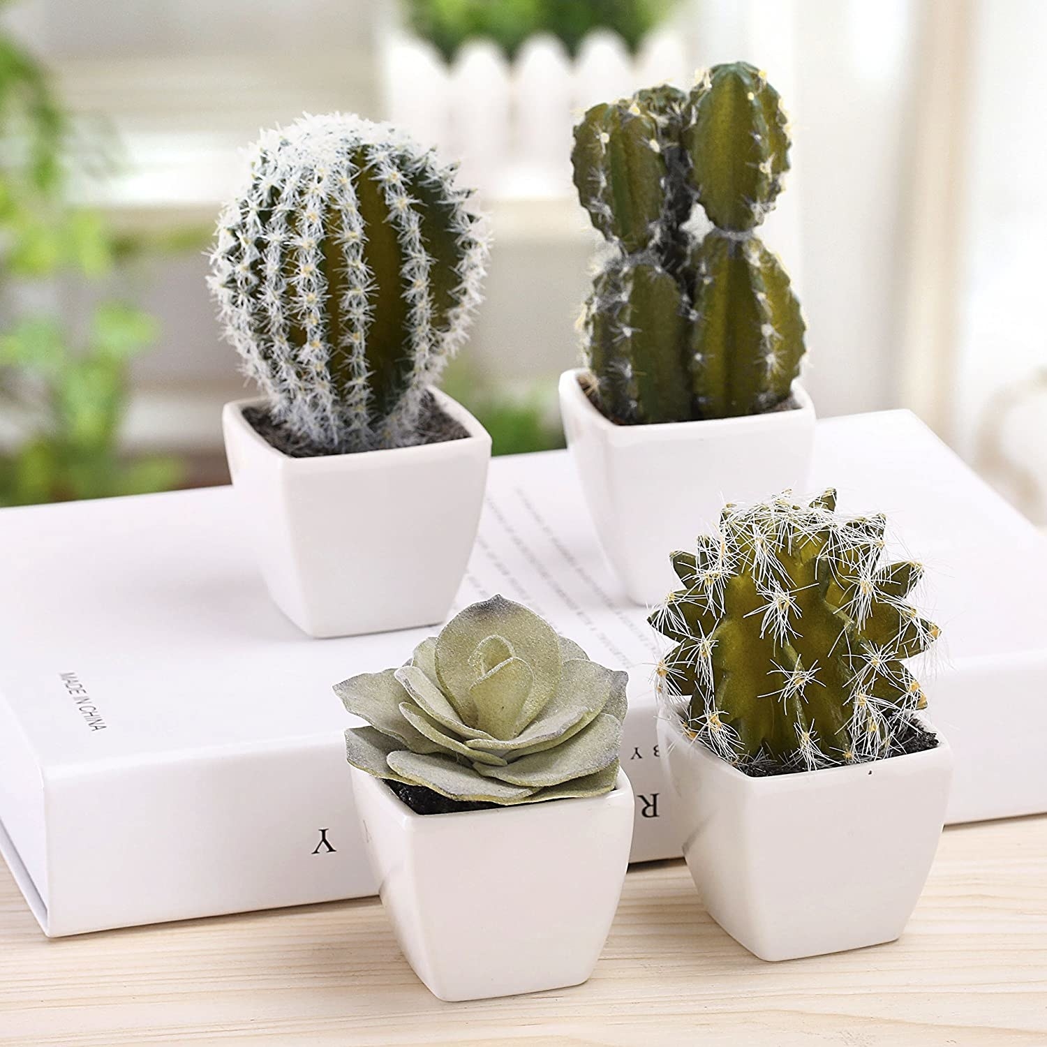 A set of four various small 5&quot; faux cacti in white pots